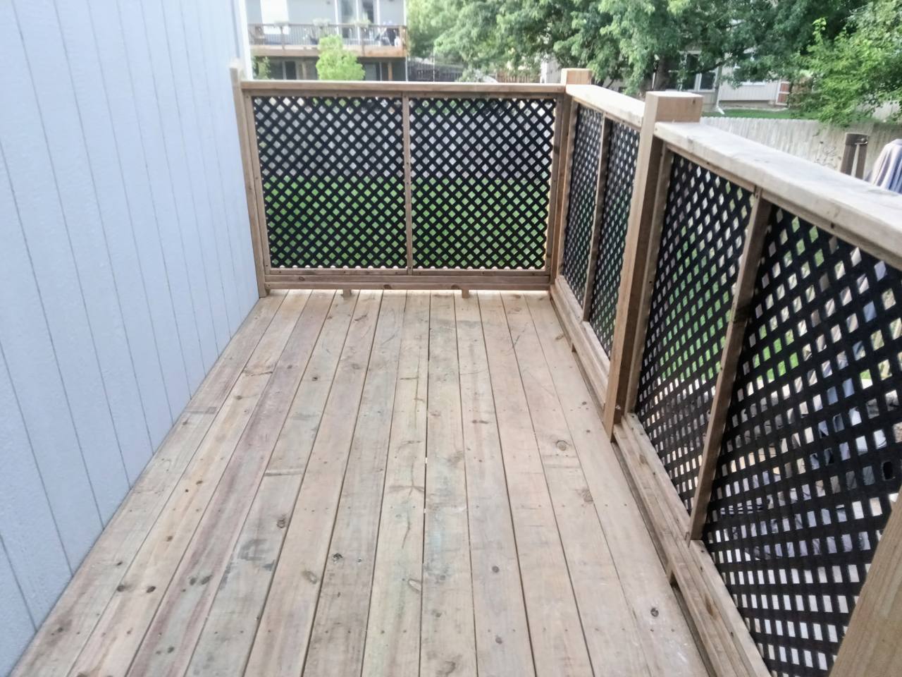 Finished deck surface and lattice privacy railing viewed from above