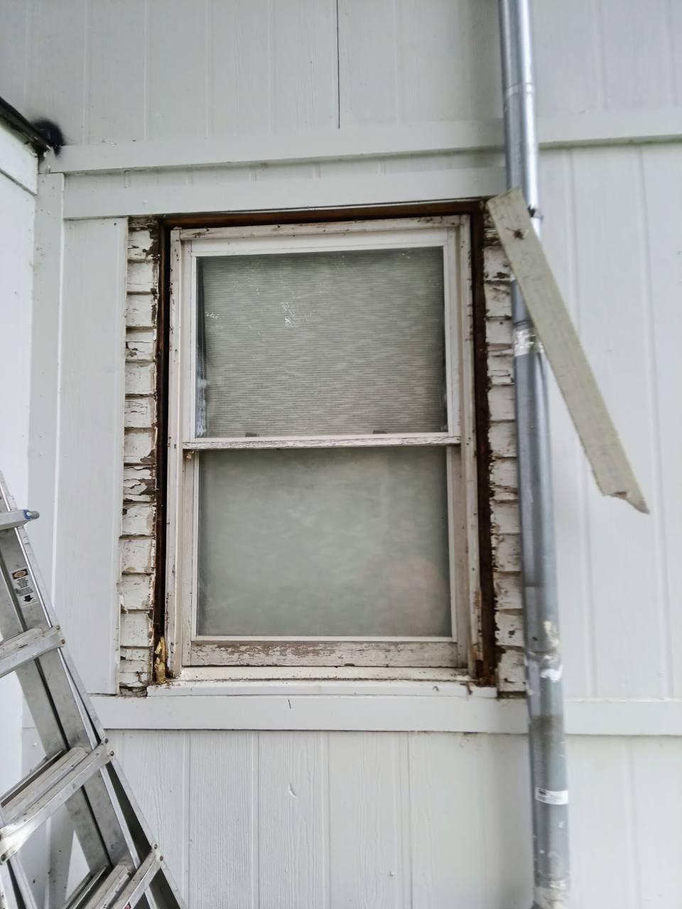Window opening before repair with deteriorated exterior trim exposed